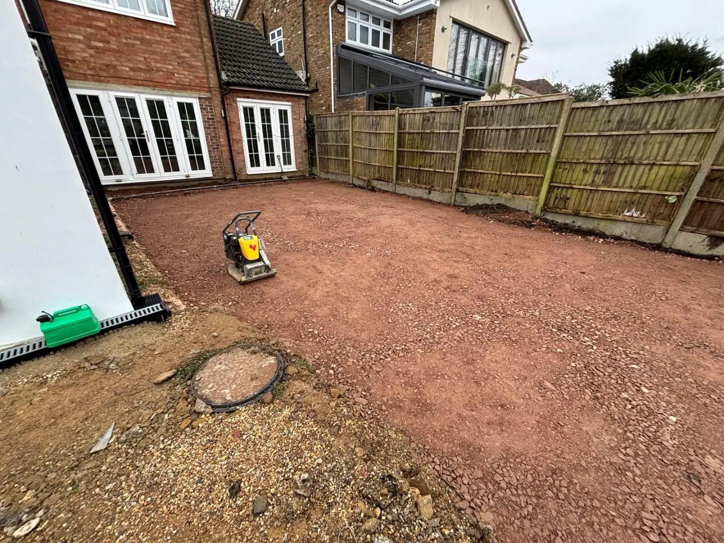 Compacted stone sub-base prepared beneath the future terrace and paths