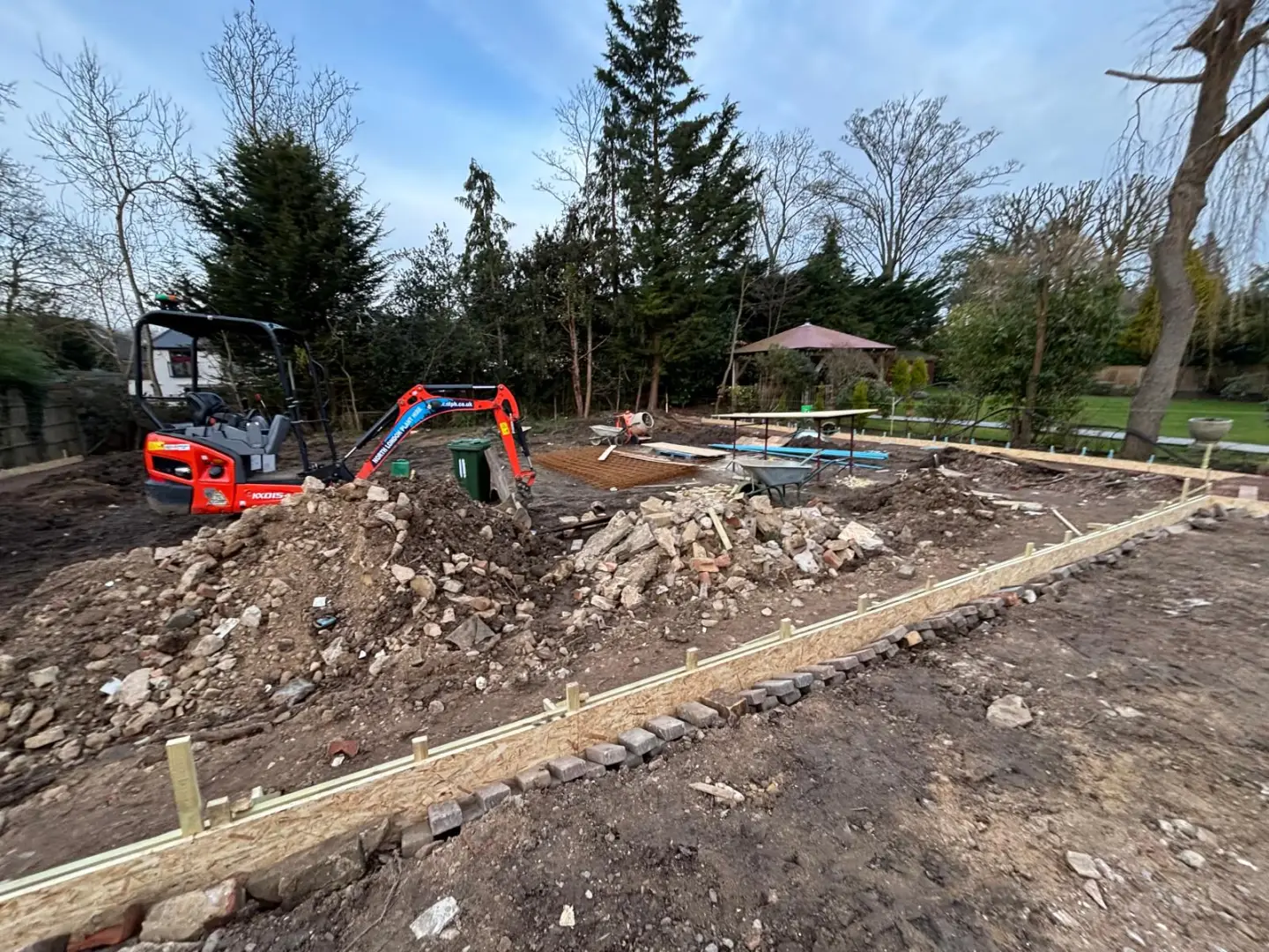 Machine excavation and ground preparation across the rear garden