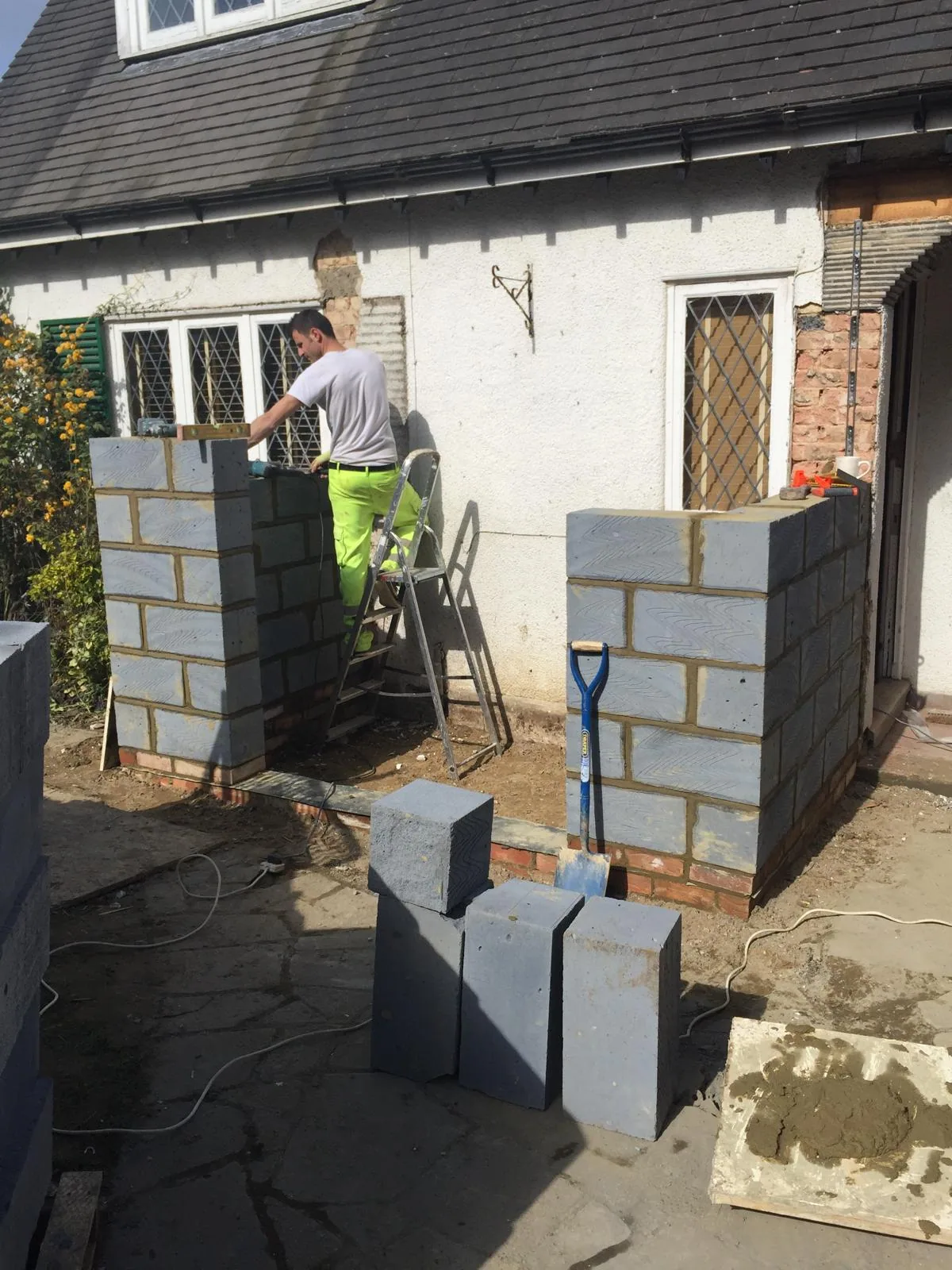 Residential renovation showing new masonry and blockwork in progress.