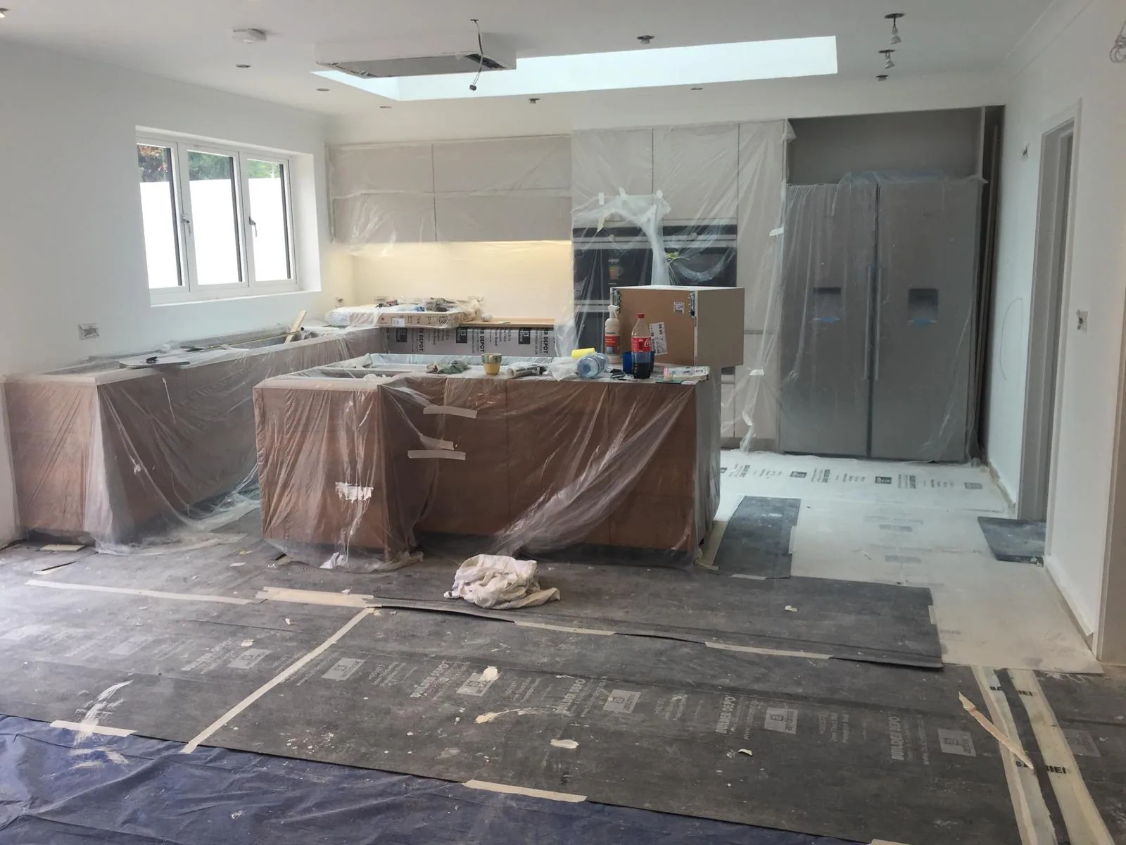 Renovation interior showing a kitchen area protected during construction.
