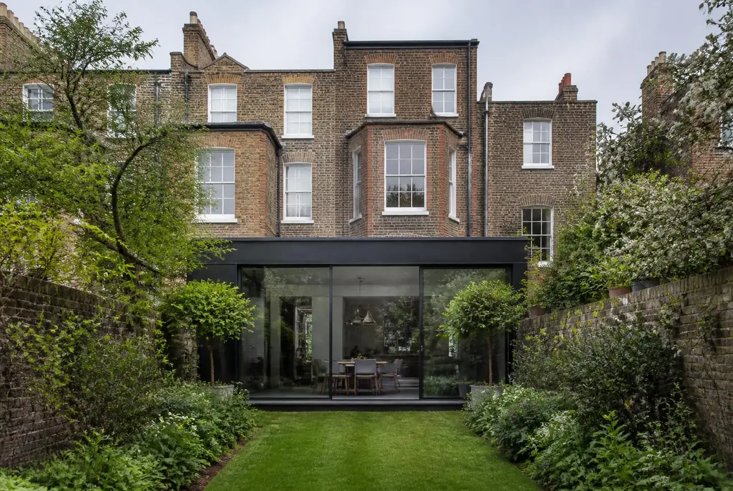 Rear elevation of a North London home with glazed extension and terrace