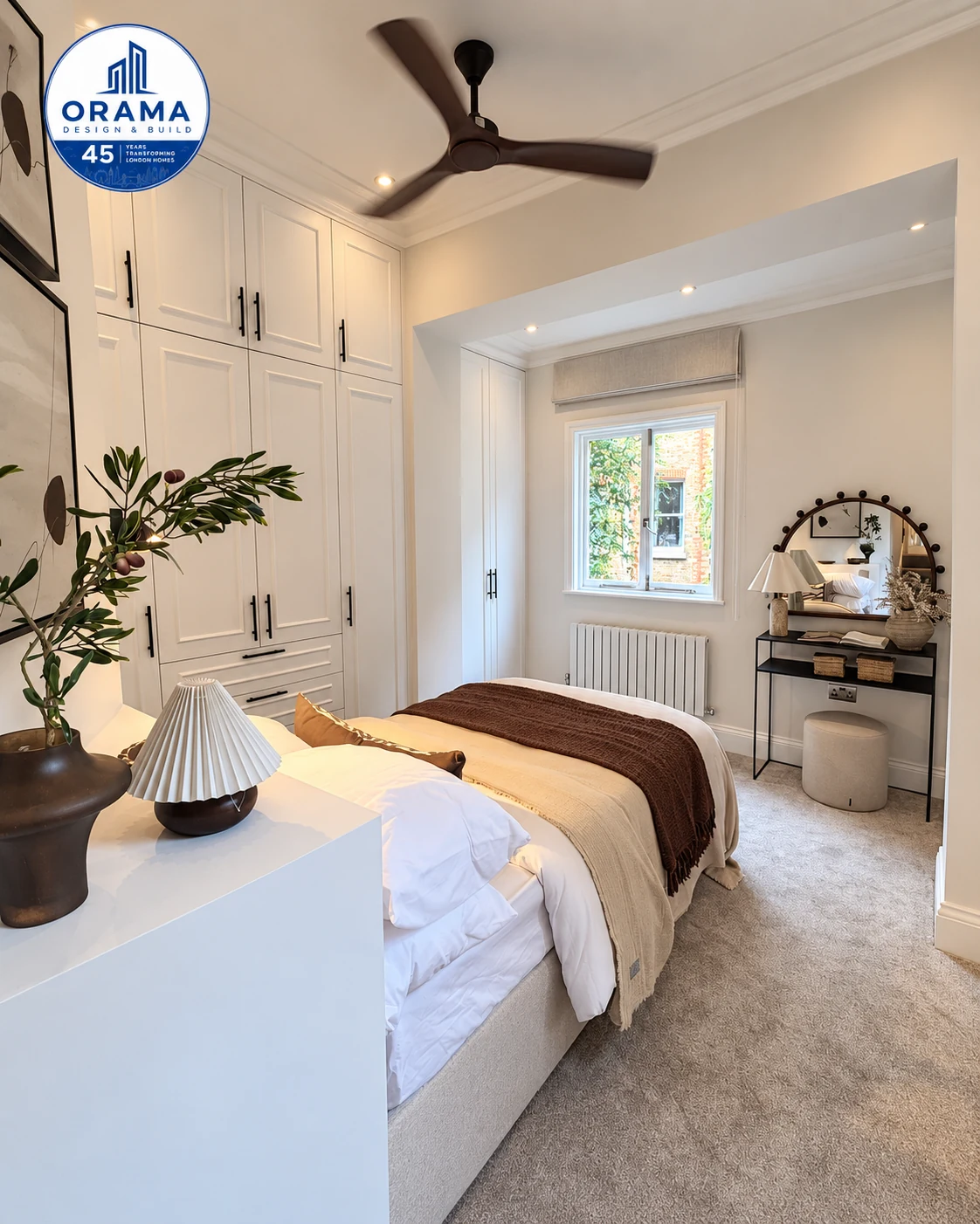 Calm guest bedroom with neutral linens and warm lighting