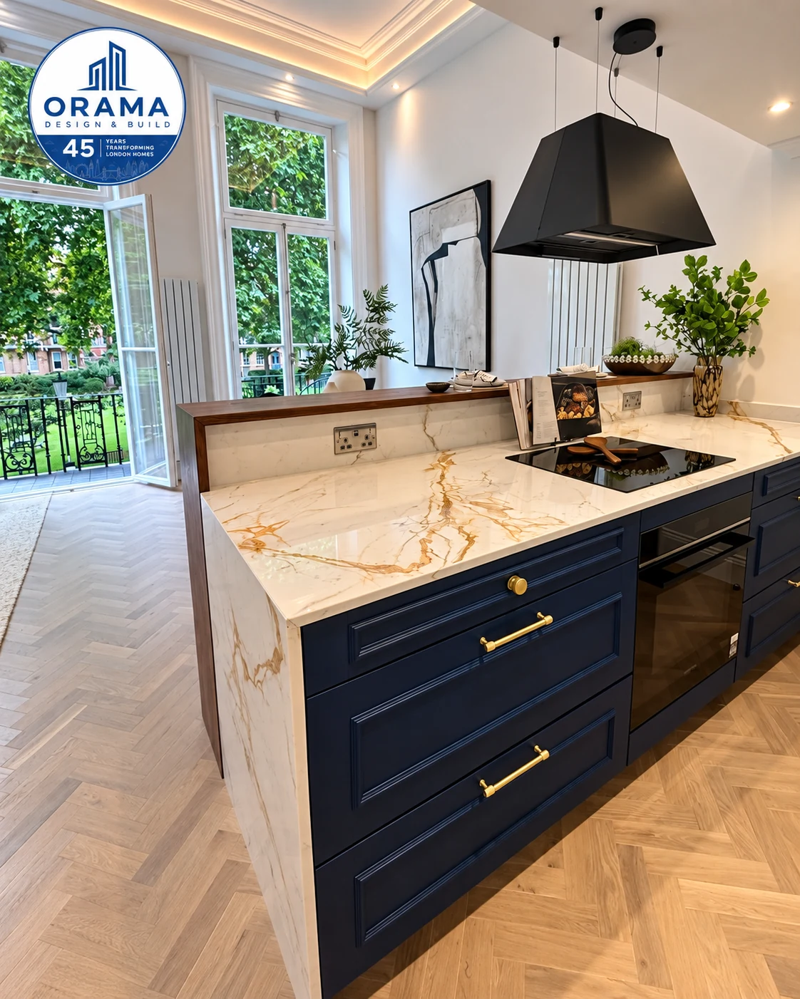 Dark navy kitchen island with marble counter and expansive garden view