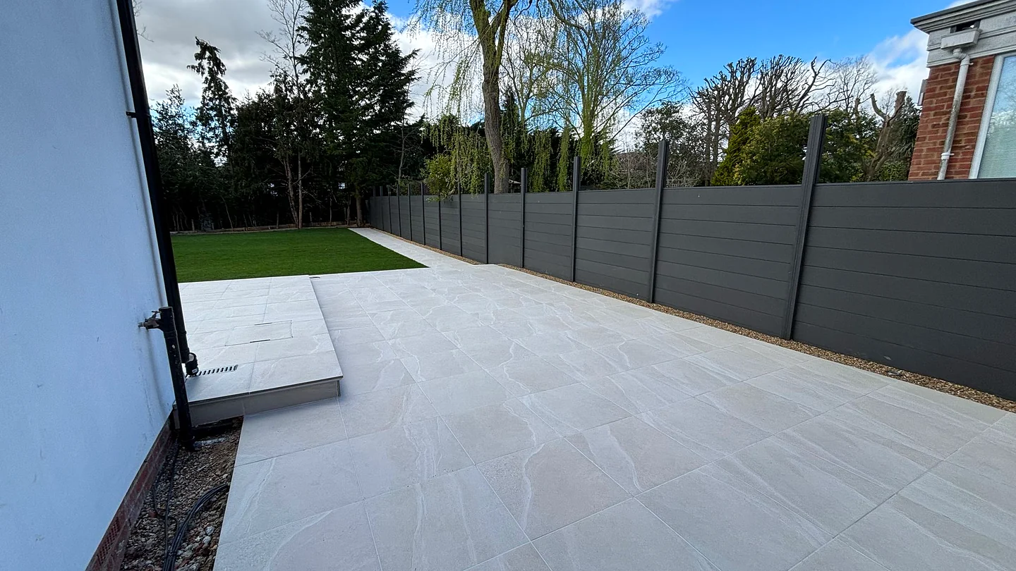 Italian porcelain terrace with flush threshold drainage and anthracite fencing in Hadley Wood EN4