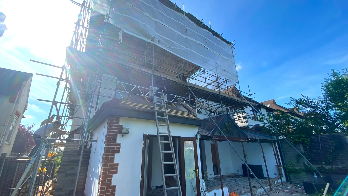 Double-storey rear extension under construction with independent scaffold tower in Highgate N6
